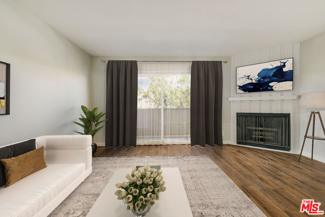 1342 Harvard Street, Unit 201 Santa Monica, CA 90404 - Photo 2 of 15 a living room with furniture and a fireplace