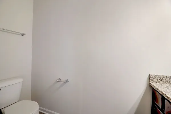 a white toilet sitting next to a shower