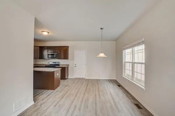 a view of kitchen with sink and wooden floor