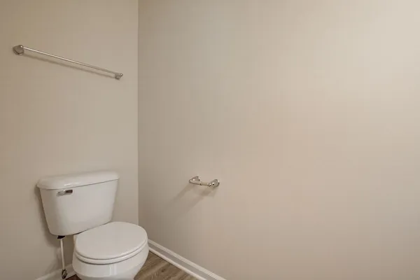 a white toilet sitting next to a shower