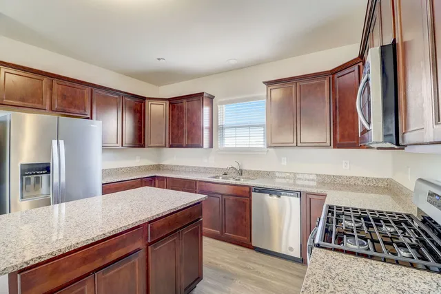 a kitchen with a sink stove and refrigerator