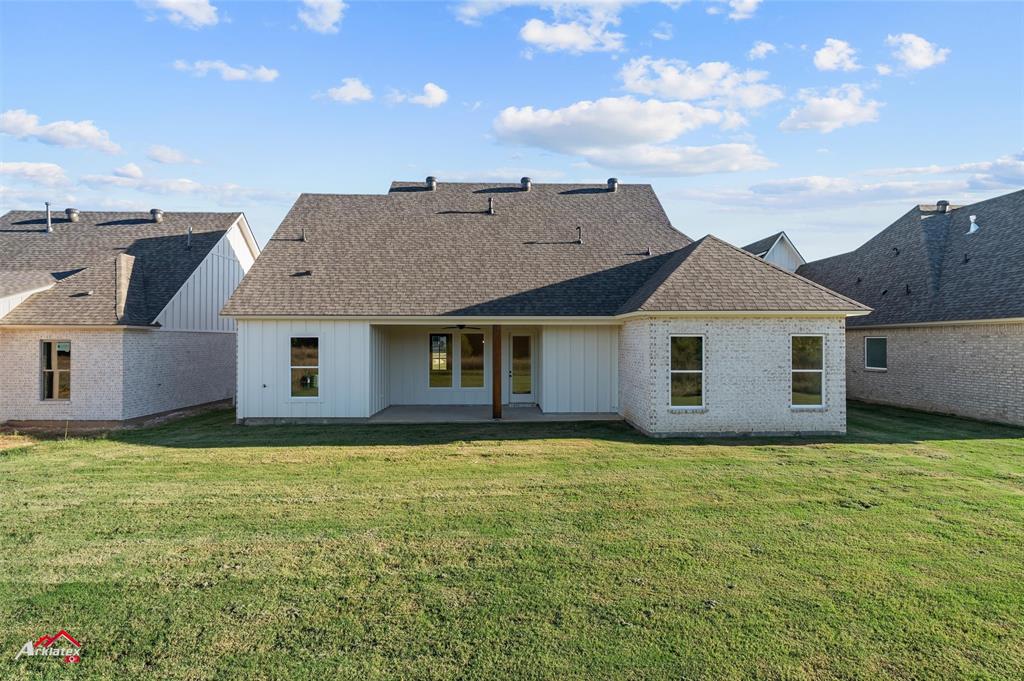 35 Turtle Creek Drive Benton, LA 71006 - Photo 31 of 32 a house that is sitting in the grass with large windows