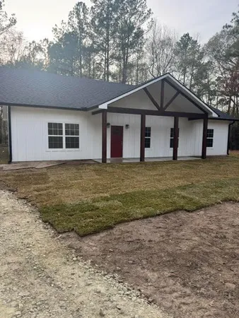 a house that has a large tree in front of it