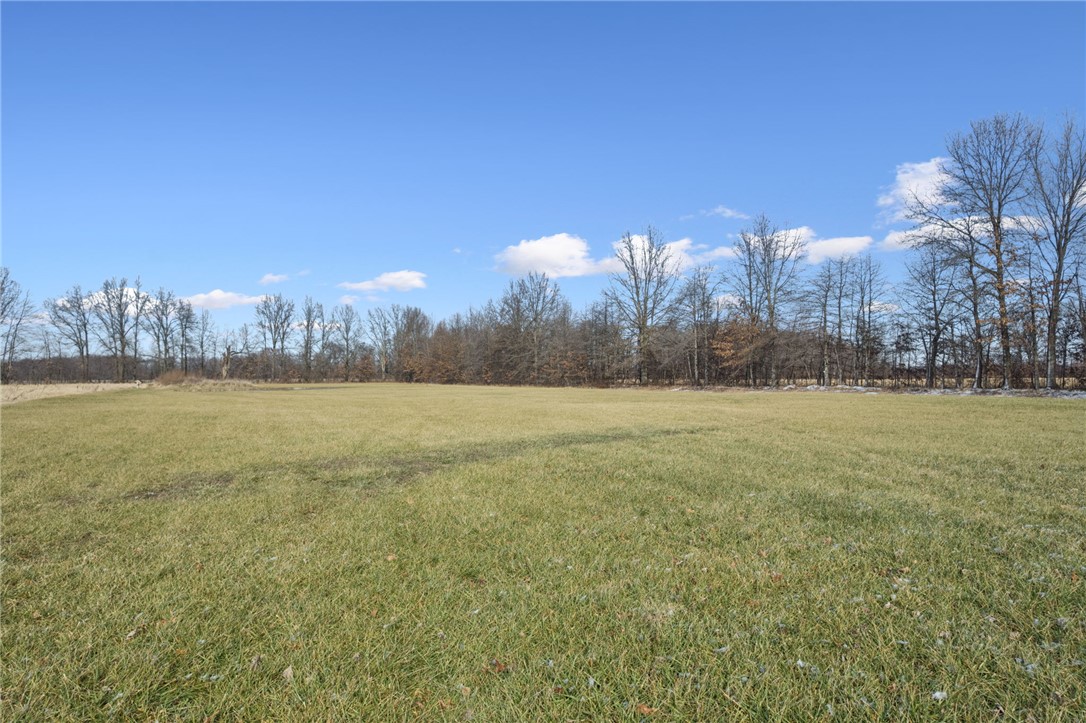 1602 Westboro Road Blanchester, OH 45107 - Photo 38 of 81 A spacious expanse of green field awaits your vision under a bright blue sky.