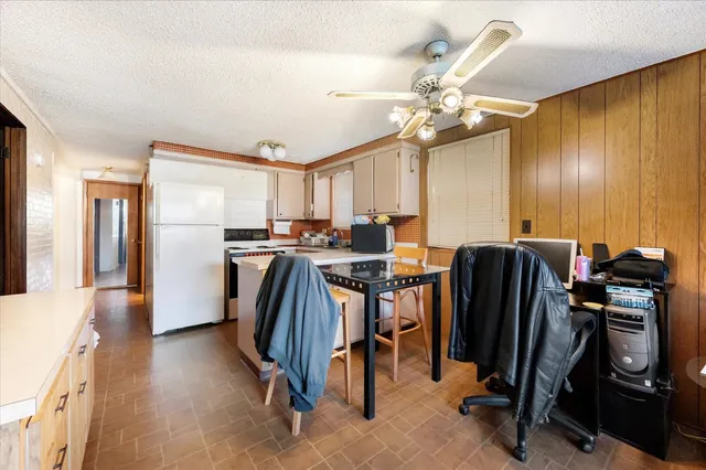 a view of a kitchen with fridge and workspace