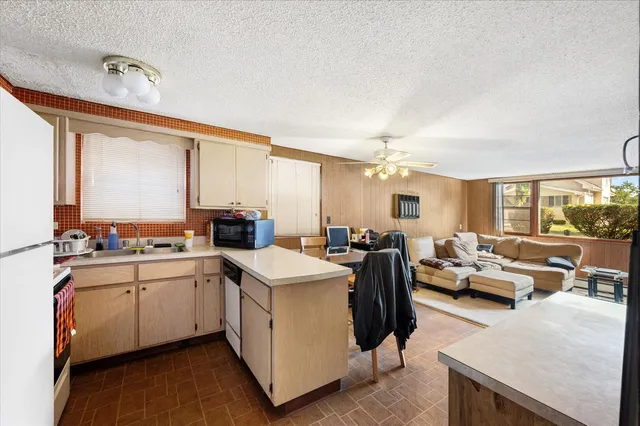 a kitchen with sink attached with living room