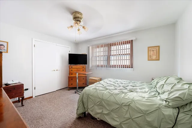 a bed room with a bed and a television