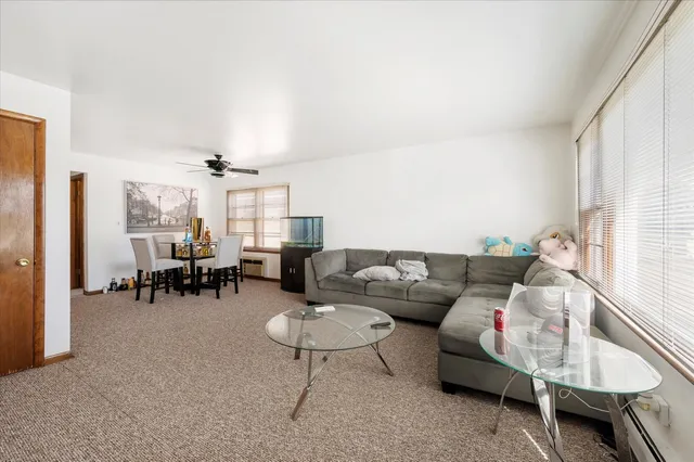 a living room with furniture and a dining table with kitchen view