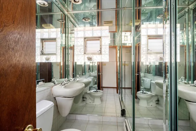 a bathroom with a toilet and a shower