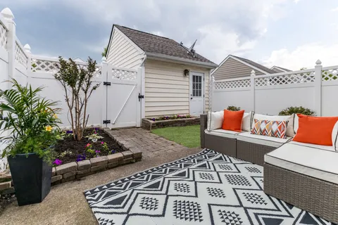 a terrace with outdoor seating and flowers