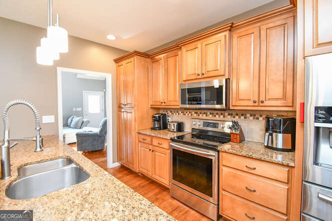 290 Eli Knob Road Dahlonega, GA 30533 - Photo 12 of 87 a kitchen with stainless steel appliances granite countertop a stove a sink and a microwave