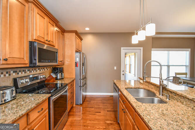 290 Eli Knob Road Dahlonega, GA 30533 - Photo 15 of 87 a kitchen with a stove a sink and a microwave