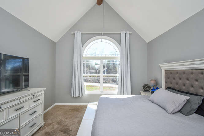 290 Eli Knob Road Dahlonega, GA 30533 - Photo 25 of 87 a bedroom with a bed and a flat screen tv