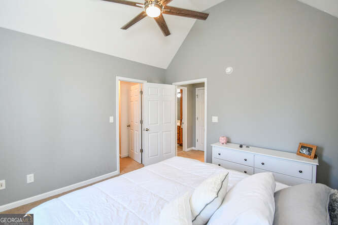 290 Eli Knob Road Dahlonega, GA 30533 - Photo 51 of 87 a bedroom with a bed and a chandelier