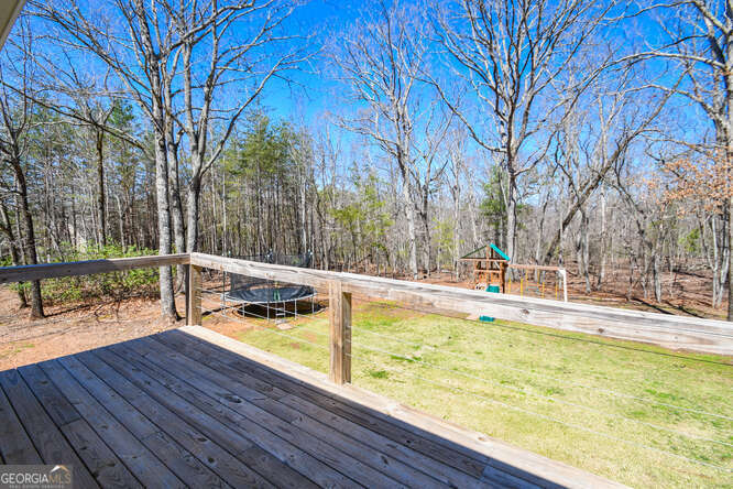 290 Eli Knob Road Dahlonega, GA 30533 - Photo 55 of 87 a view of a swimming pool with a patio and wooden fence