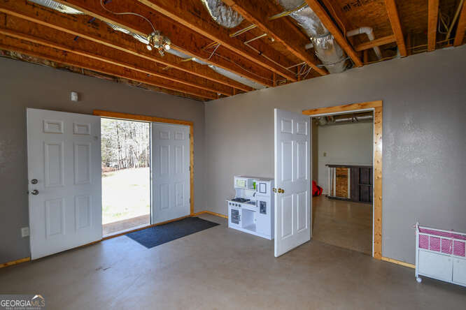 290 Eli Knob Road Dahlonega, GA 30533 - Photo 69 of 87 a view of empty room with wooden floor and cabinet
