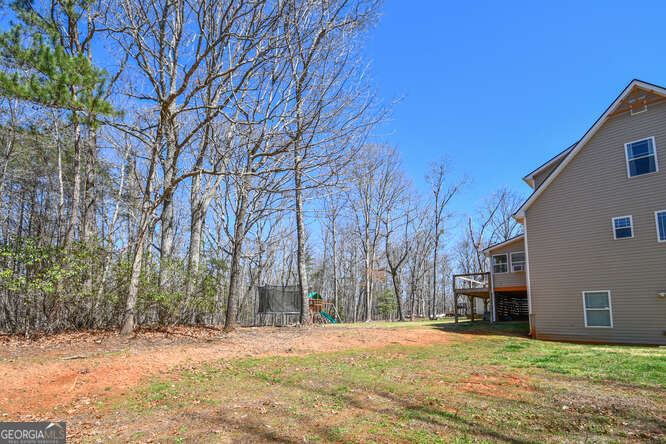 290 Eli Knob Road Dahlonega, GA 30533 - Photo 79 of 87 a backyard of a house with large trees
