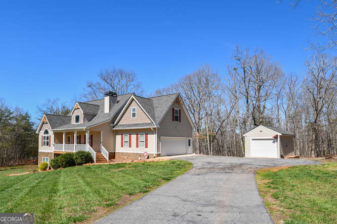 290 Eli Knob Road Dahlonega, GA 30533 - Photo 87 of 87 a front view of a house with a garden and trees