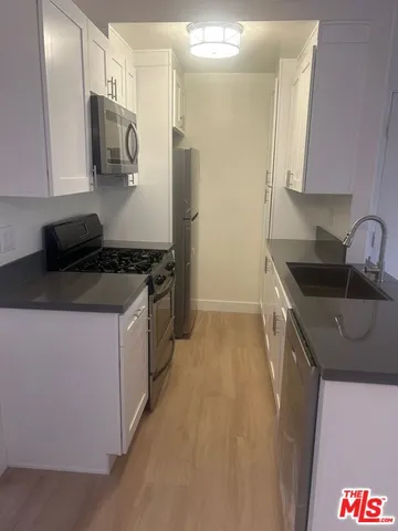a kitchen that has a sink and a stove in it