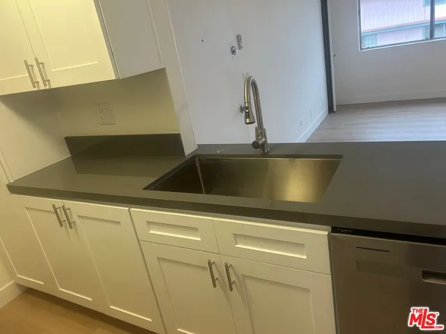 a close view of sink and cabinets