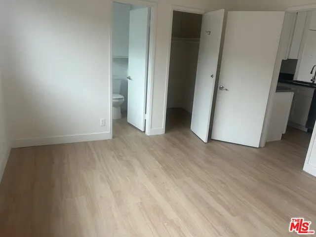 an empty room with wooden floor and a window