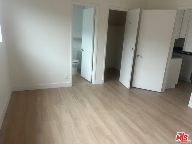 an empty room with wooden floor and a window