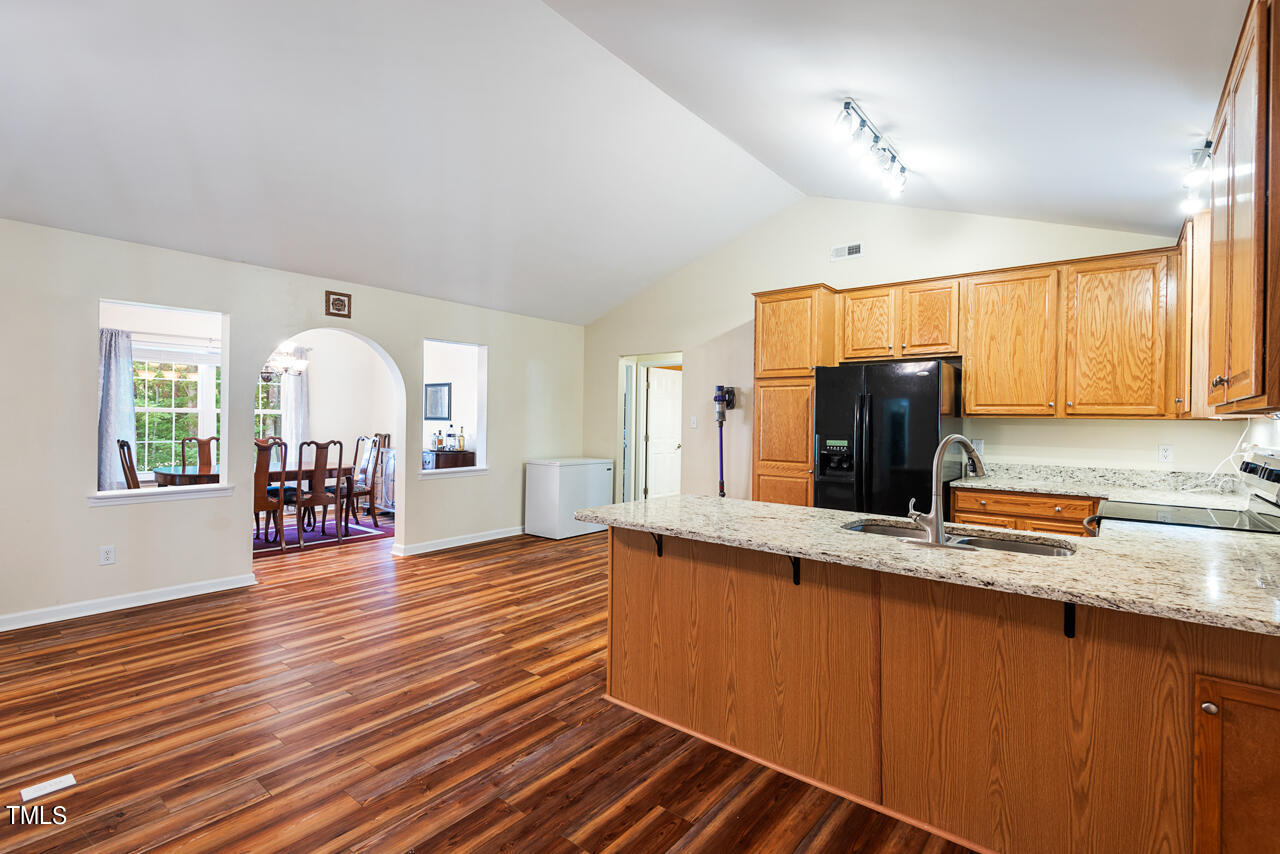 2023 Antioch Church Road Timberlake, NC 27583 - Photo 9 of 40 a view of a kitchen with a sink a refrigerator wooden cabinets and a window
