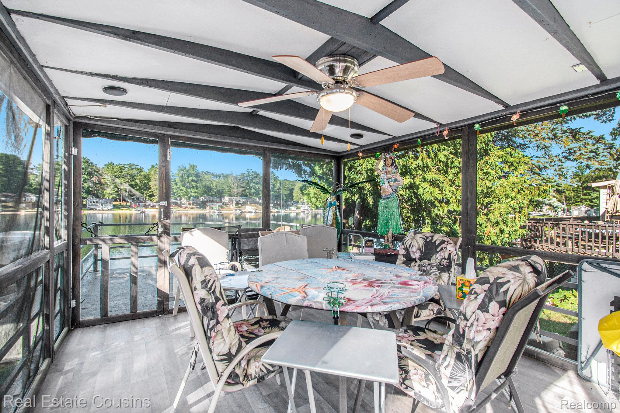 1734 Forest Road Harrison, MI 48625 - Photo 20 of 31 Sunroom / solarium featuring a ceiling fan, a water view, and outdoor dining area