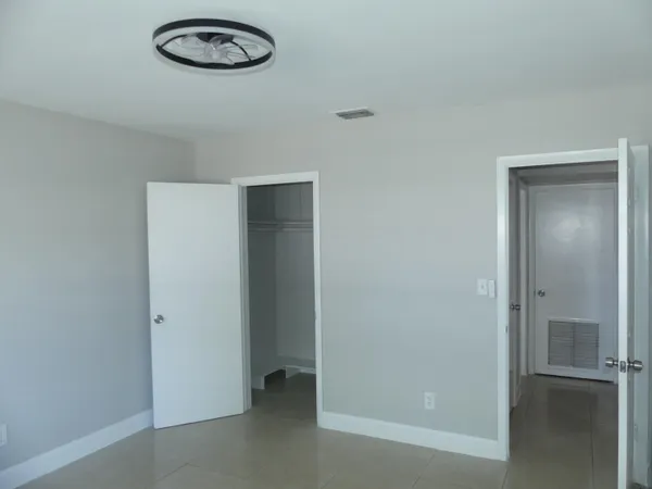 a white toilet sitting next to a bathroom sink and tub