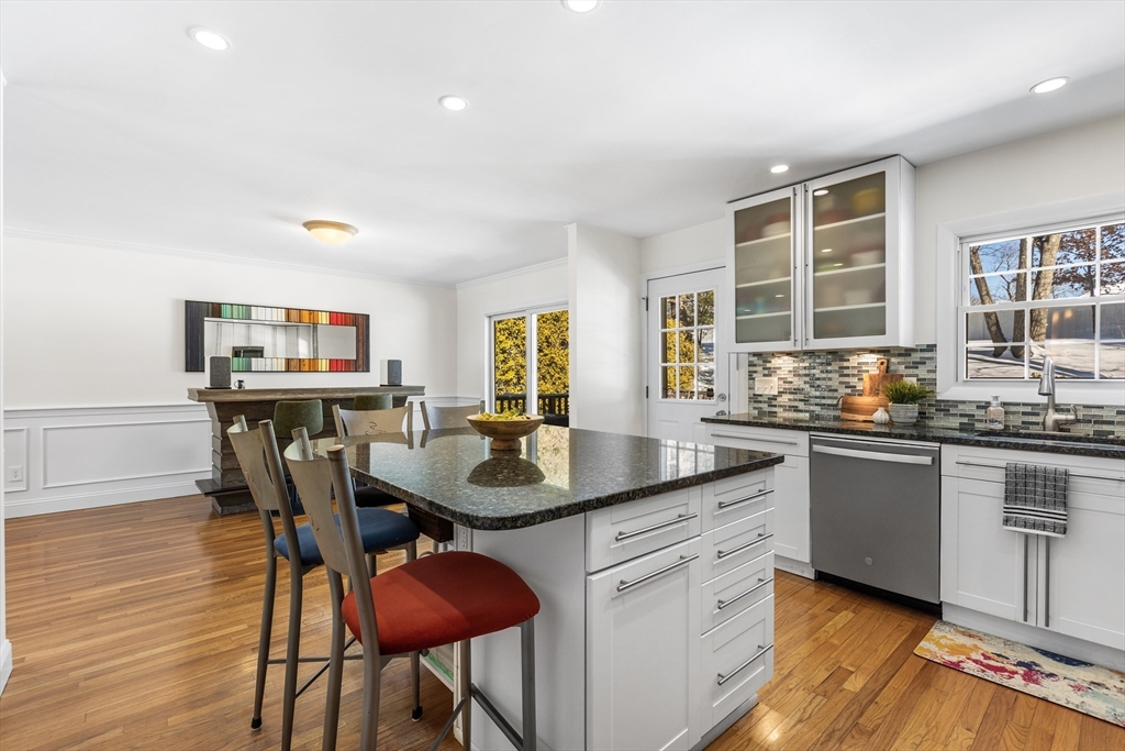 27 Audubon Road Reading, MA 01867 - Photo 11 of 35 a kitchen with granite countertop kitchen island a table and chairs in it