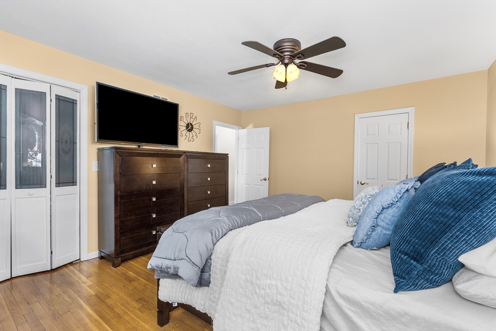 27 Audubon Road Reading, MA 01867 - Photo 16 of 35 a bedroom with a bed and a flat screen tv