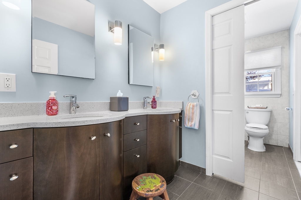 27 Audubon Road Reading, MA 01867 - Photo 18 of 35 a bathroom with a granite countertop sink toilet and shower