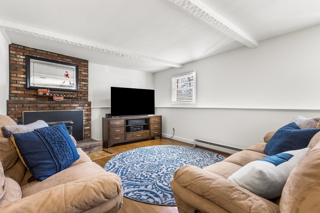 27 Audubon Road Reading, MA 01867 - Photo 23 of 35 a living room with furniture and a flat screen tv