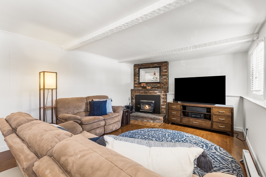 27 Audubon Road Reading, MA 01867 - Photo 25 of 35 a living room with furniture and a flat screen tv