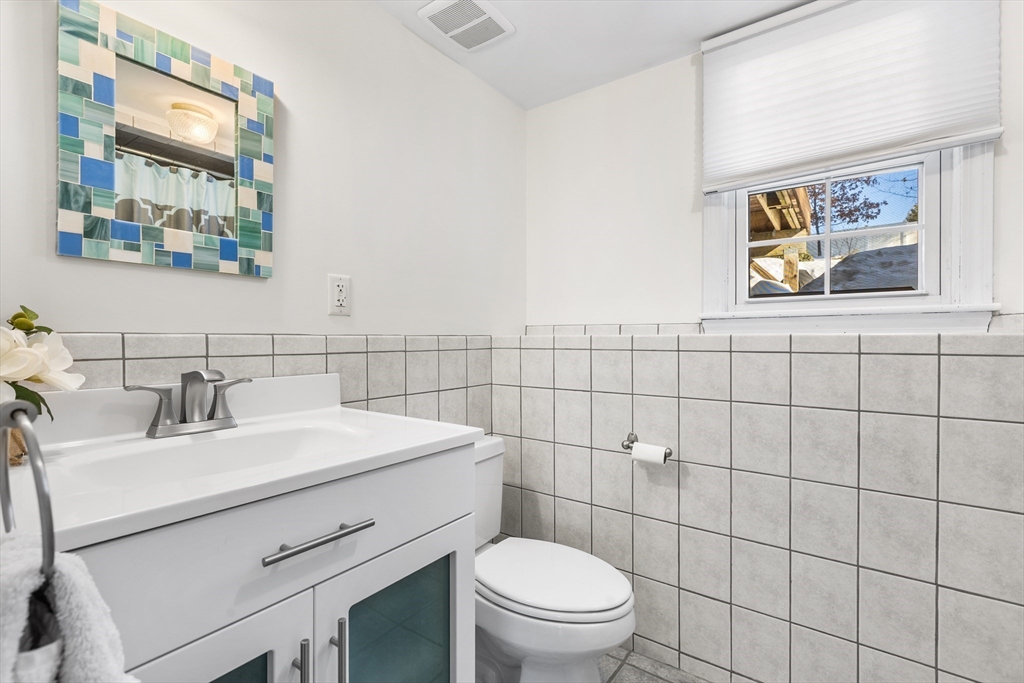 27 Audubon Road Reading, MA 01867 - Photo 27 of 35 a bathroom with a sink mirror vanity and toilet