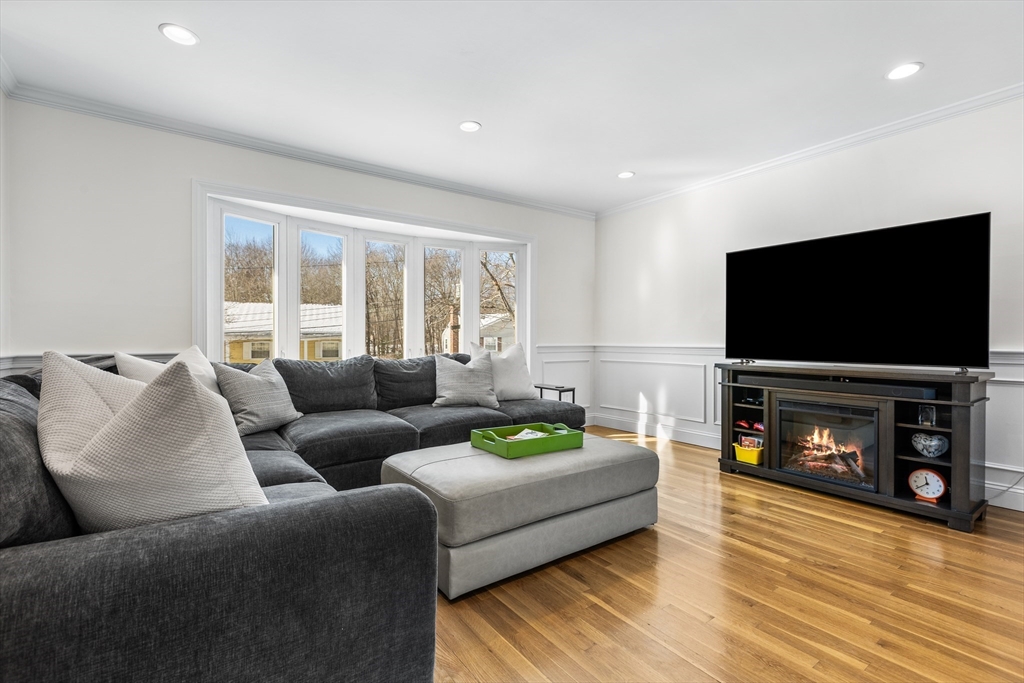 27 Audubon Road Reading, MA 01867 - Photo 7 of 35 a living room with furniture and a flat screen tv