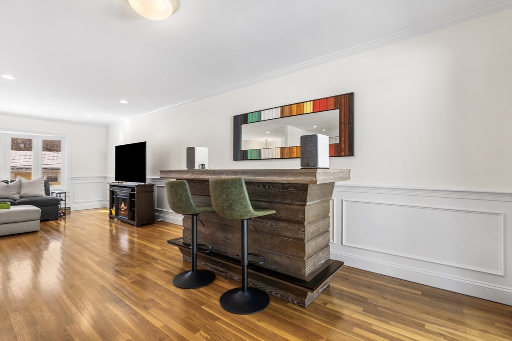 27 Audubon Road Reading, MA 01867 - Photo 9 of 35 a living room with furniture and a flat screen tv