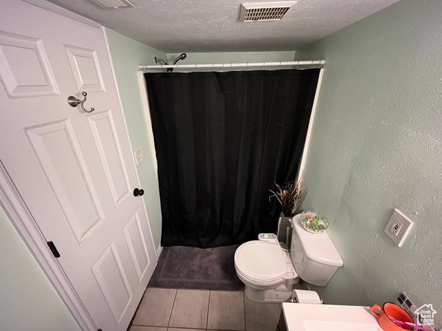 2548 South 700 West Perry, UT 84302 - Photo 11 of 18 Bathroom with tile patterned flooring, a textured ceiling, a shower with shower curtain, a textured wall, and vanity