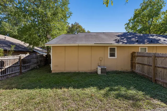 a backyard of a house with barbeque oven