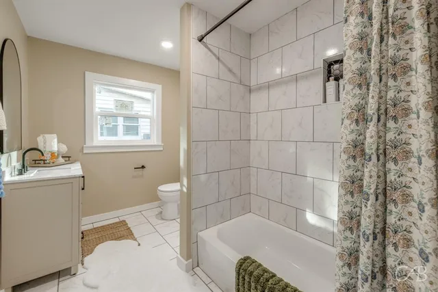 a bathroom with a bathtub and a toilet