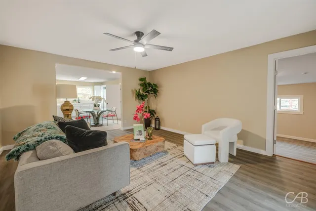 a living room with furniture and a chandelier