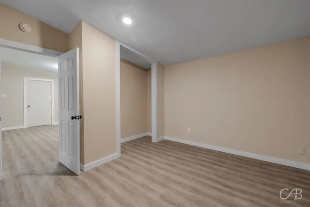 a view of hallway with wooden floor