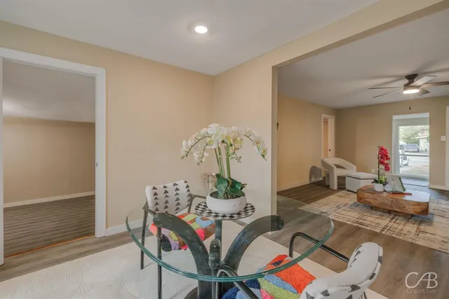 a living room with furniture and wooden floor