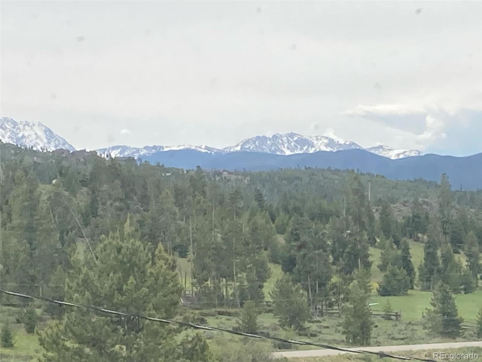 an aerial view of mountain with trees in the background