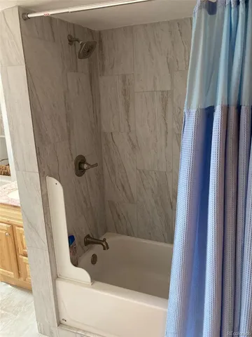 a bathroom with a tub and a shower