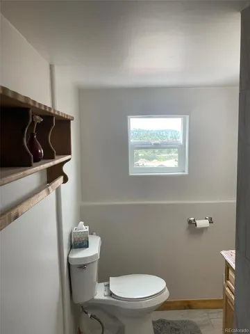 a white toilet sitting next to a window