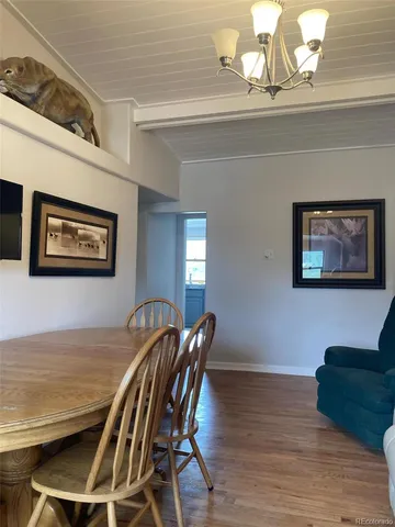 a view of a dining room with furniture wooden floor and a chandelier