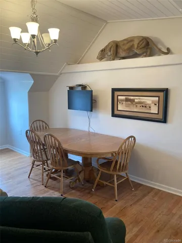 a view of a dining room with furniture and chandelier