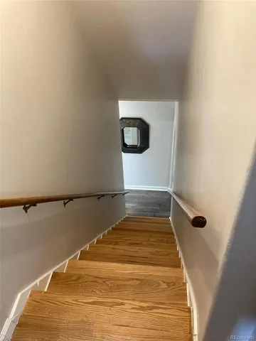 a view of a room with wooden floor
