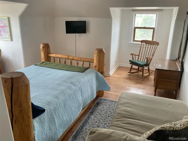 a bedroom with a bed and a chair